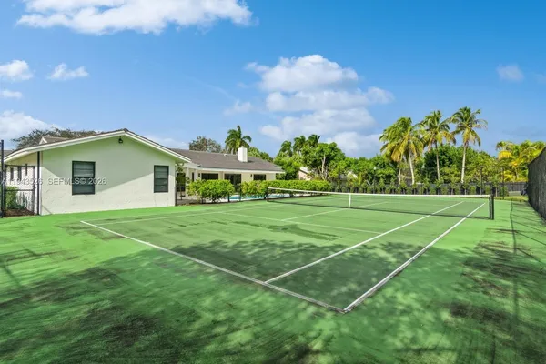 a view of a house with backyard and porch