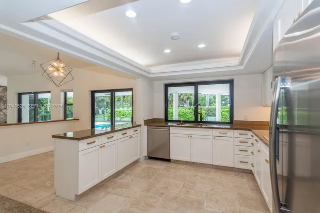 a kitchen with a refrigerator sink and cabinets