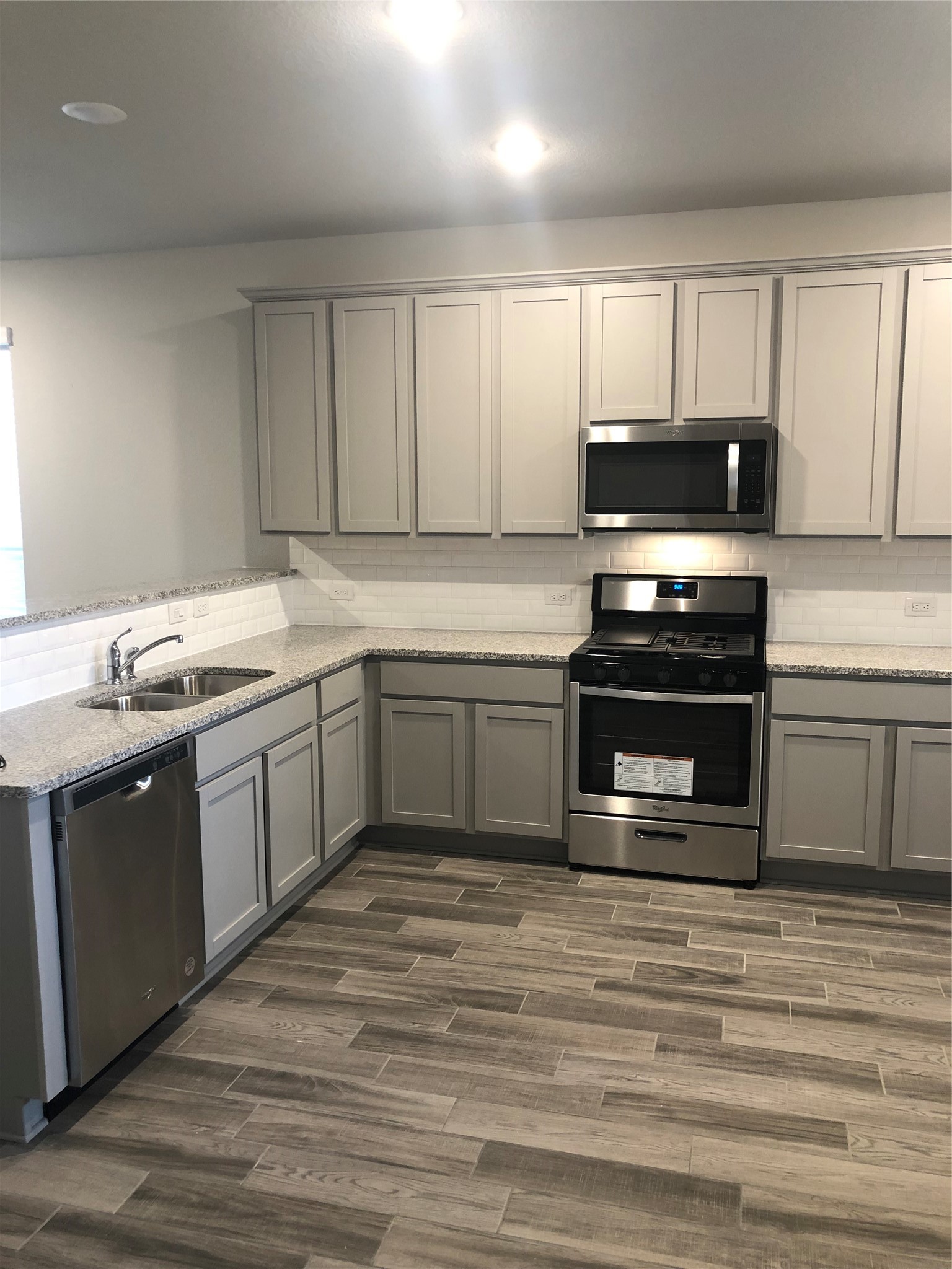 31315 Conover Drive Fulshear, TX 77441 - Photo 2 of 14 a kitchen with stainless steel appliances granite countertop a stove a sink and a microwave