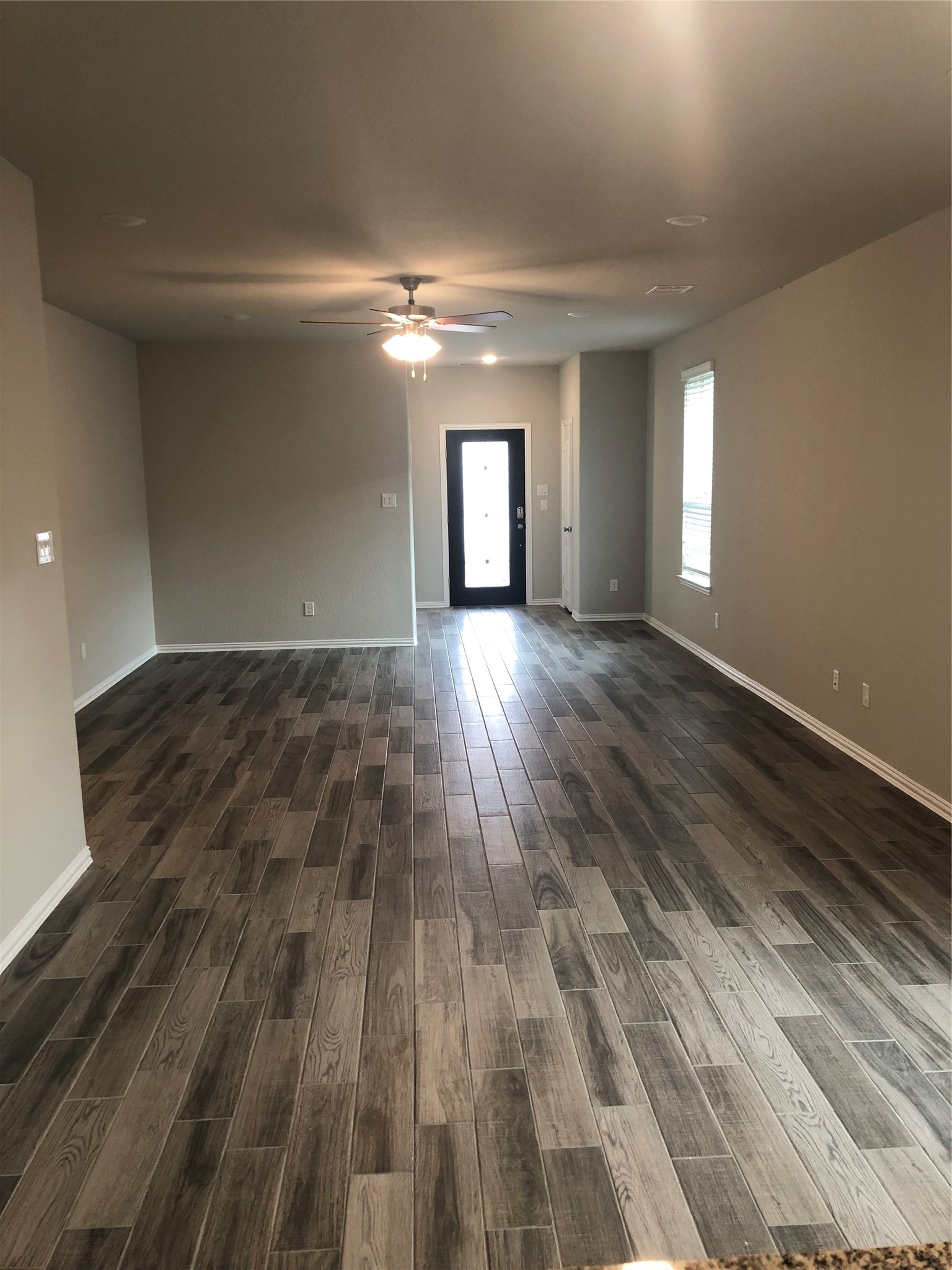 31315 Conover Drive Fulshear, TX 77441 - Photo 3 of 14 an empty room with wooden floor and windows