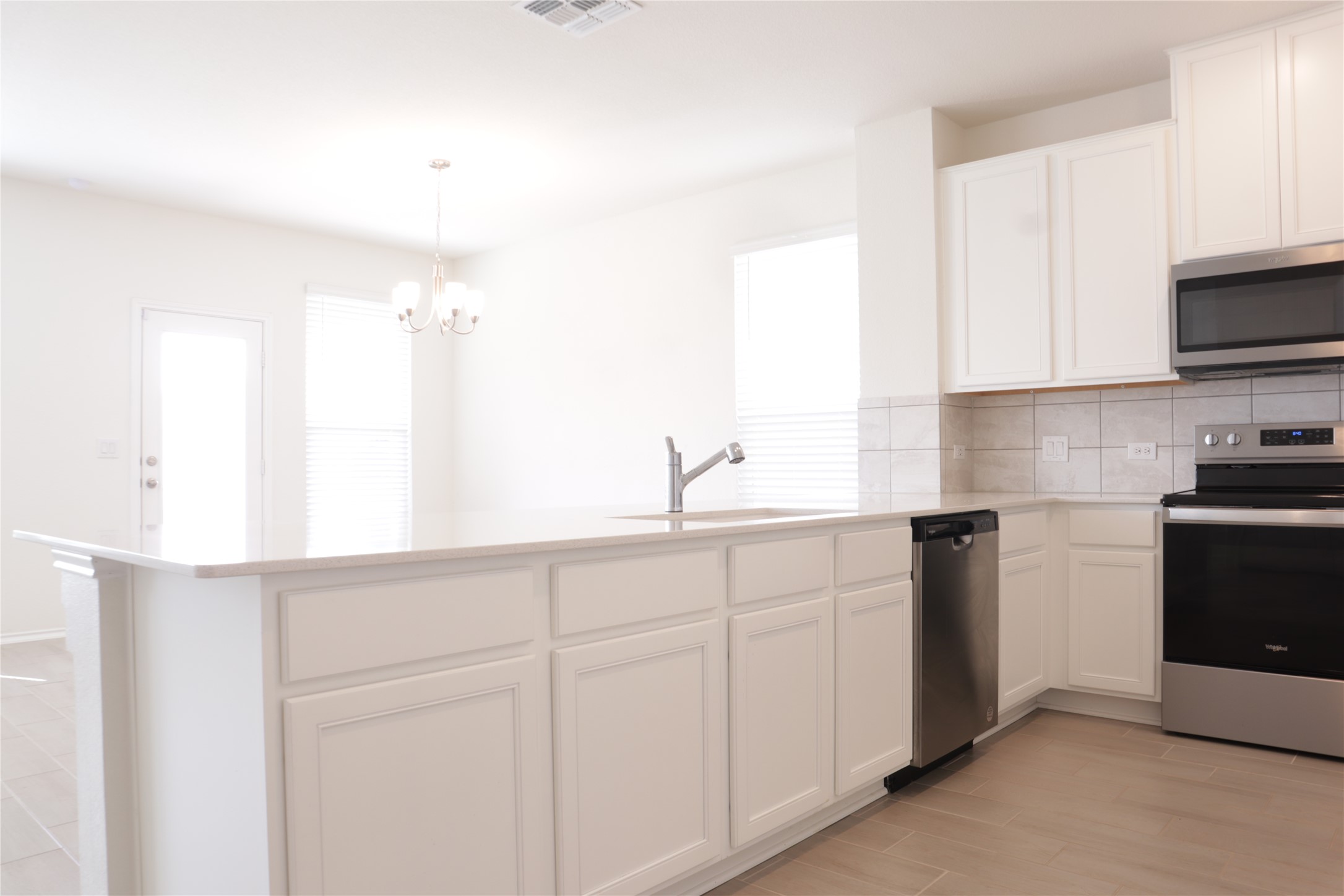 8111 Marigny Way Austin, TX 78744 - Photo 4 of 29 A well-appointed kitchen features stainless steel appliances and abundant cabinetry, offering a seamless culinary experience.