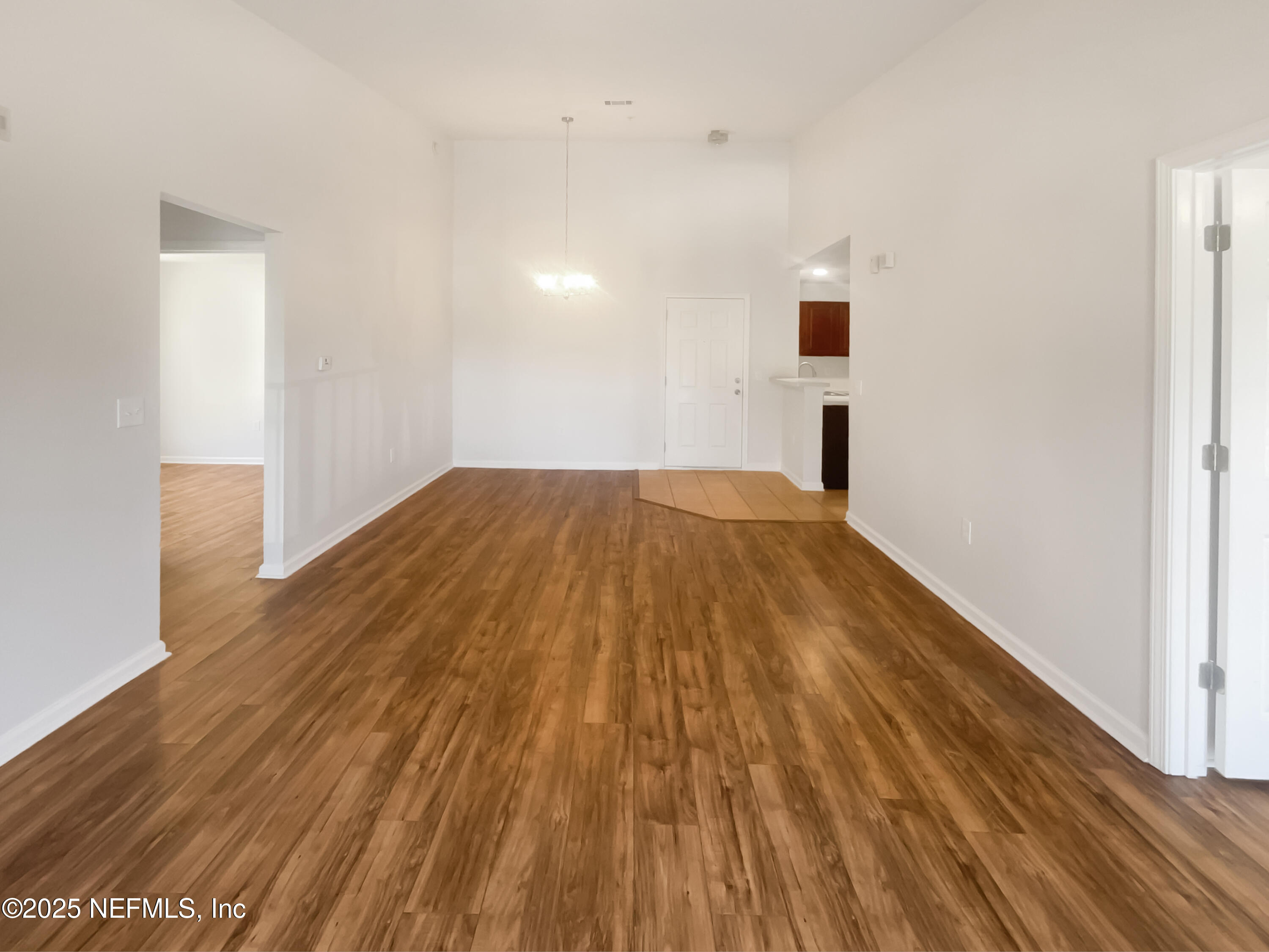 7920 Merrill Road, Unit 1115 Jacksonville, FL 32277 - Photo 11 of 19 a view of empty room with wooden floor
