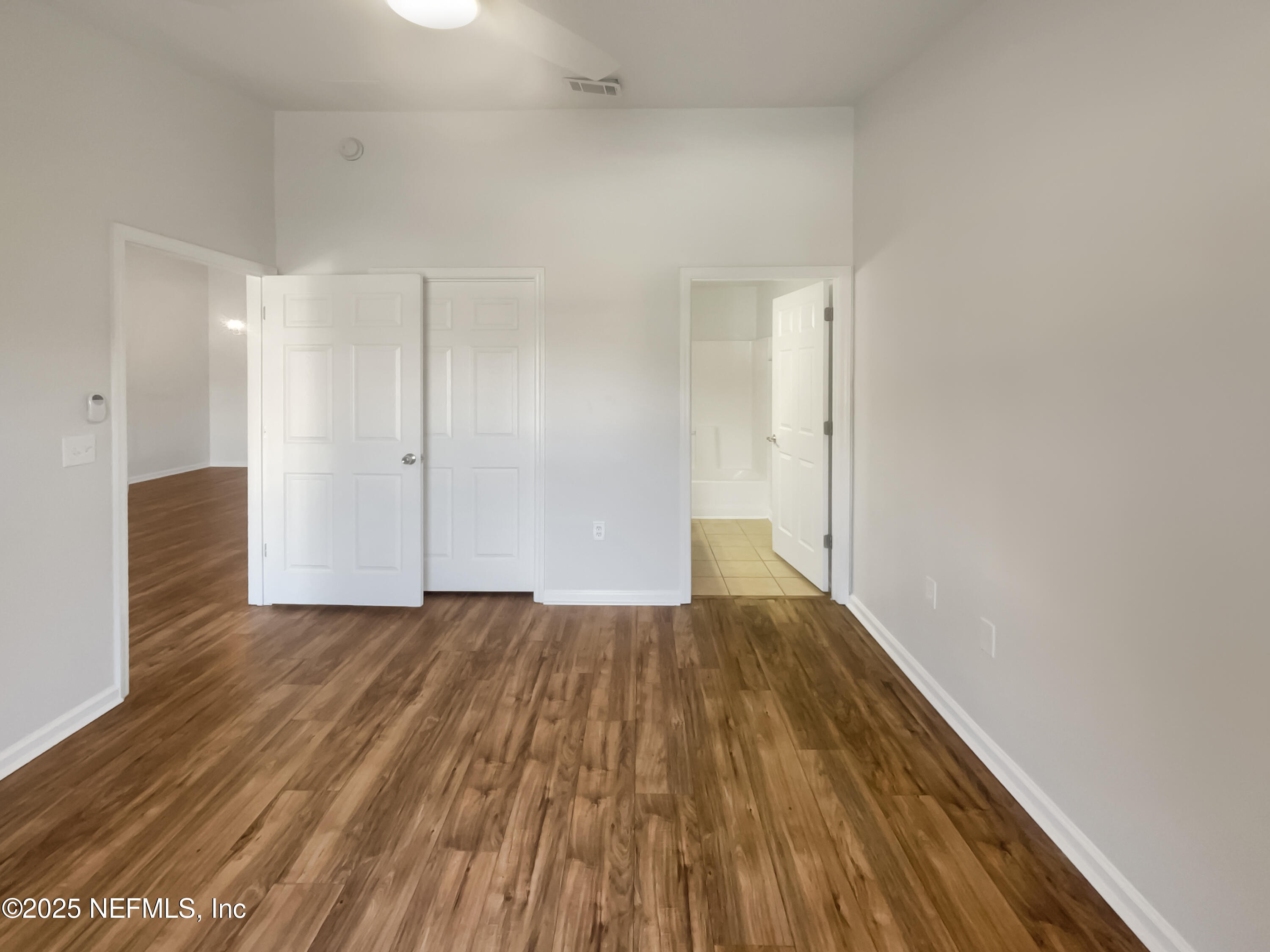 7920 Merrill Road, Unit 1115 Jacksonville, FL 32277 - Photo 12 of 19 a view of an empty room and wooden floor