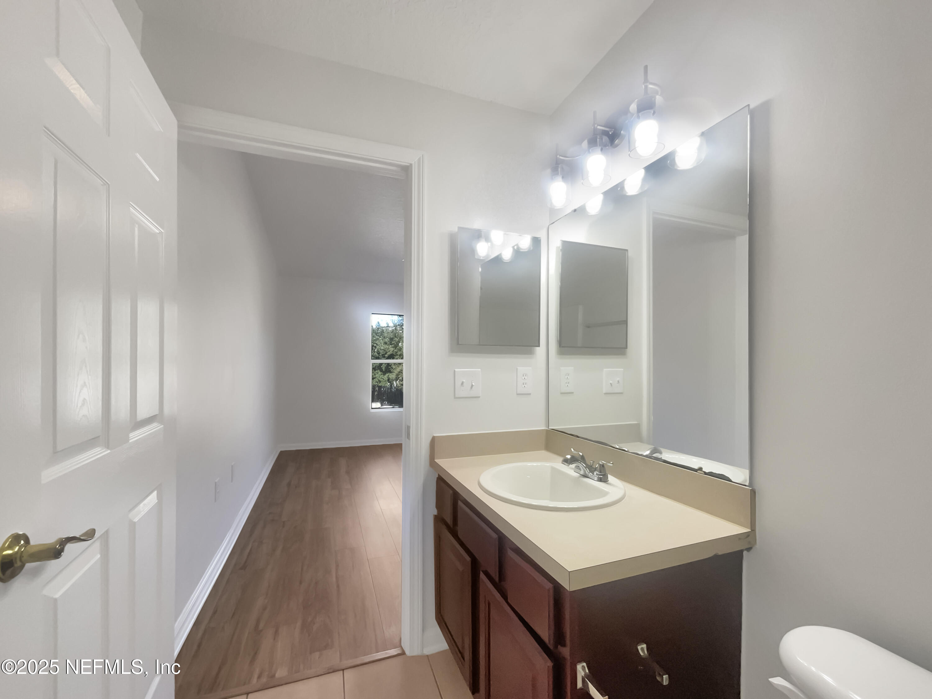 7920 Merrill Road, Unit 1115 Jacksonville, FL 32277 - Photo 14 of 19 a bathroom with a sink and a mirror