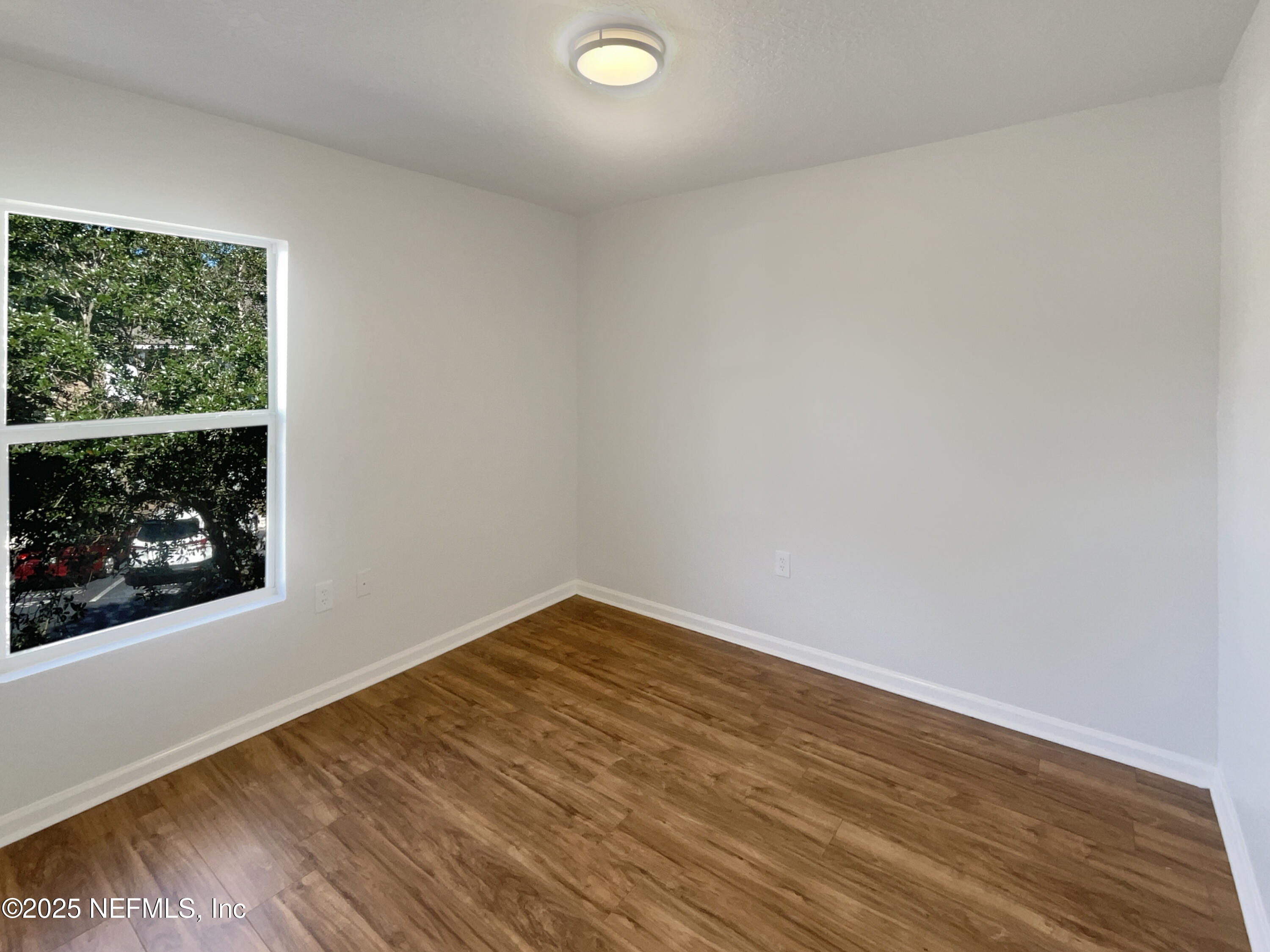 7920 Merrill Road, Unit 1115 Jacksonville, FL 32277 - Photo 15 of 19 a view of a room with wooden floor and window