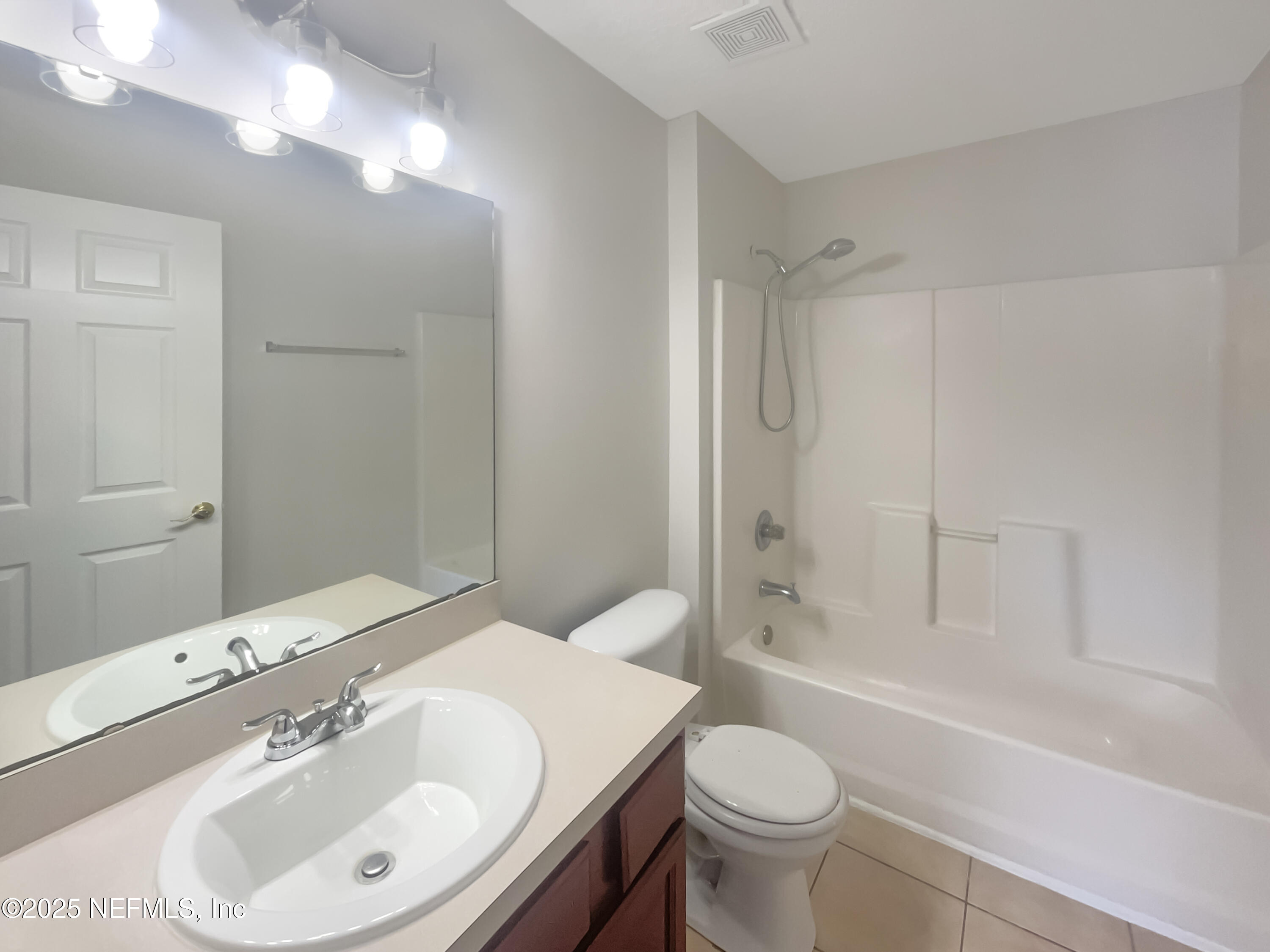 7920 Merrill Road, Unit 1115 Jacksonville, FL 32277 - Photo 7 of 19 a bathroom with a sink toilet and shower