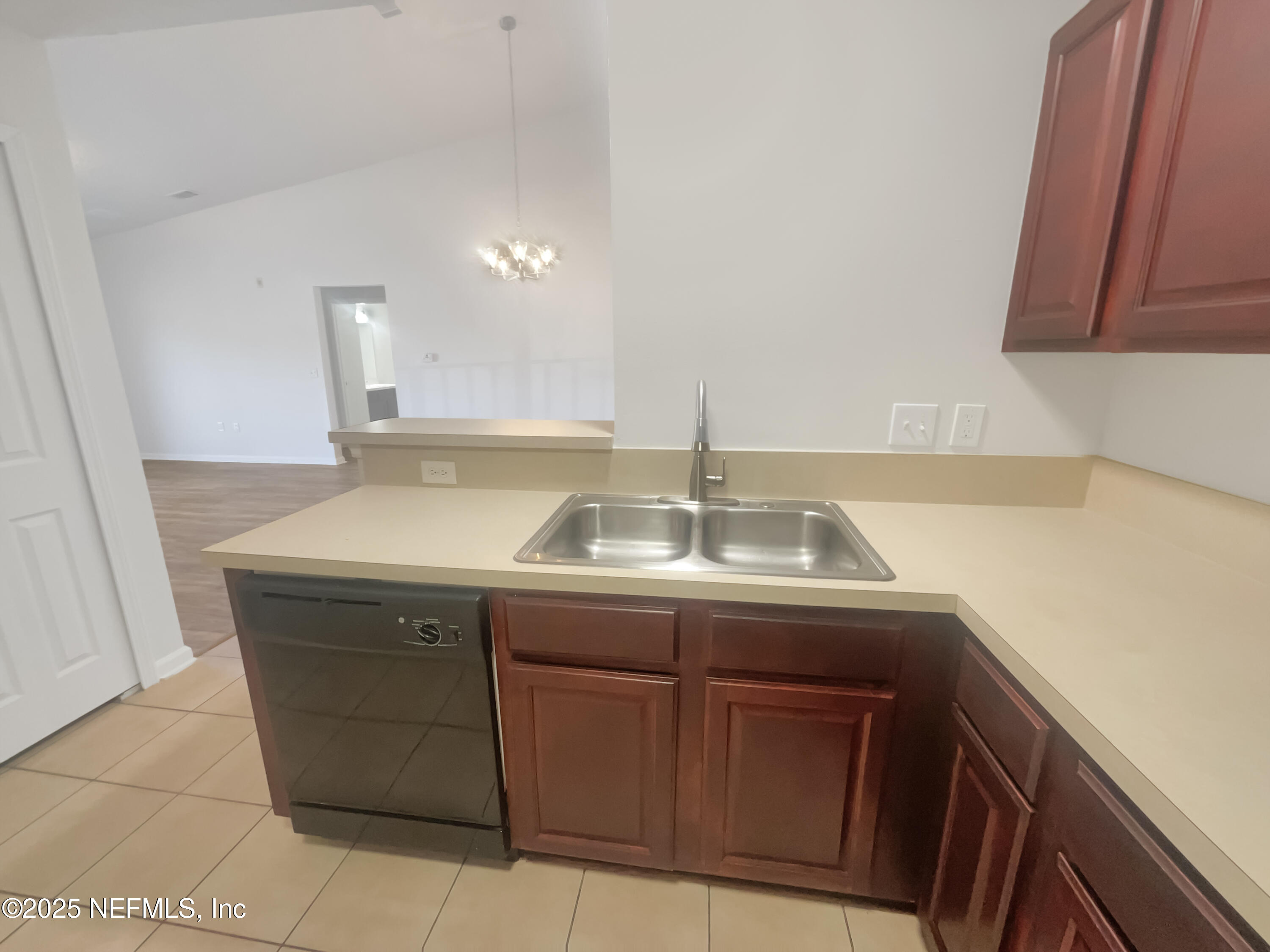 7920 Merrill Road, Unit 1115 Jacksonville, FL 32277 - Photo 10 of 19 a sink with cabinets and window