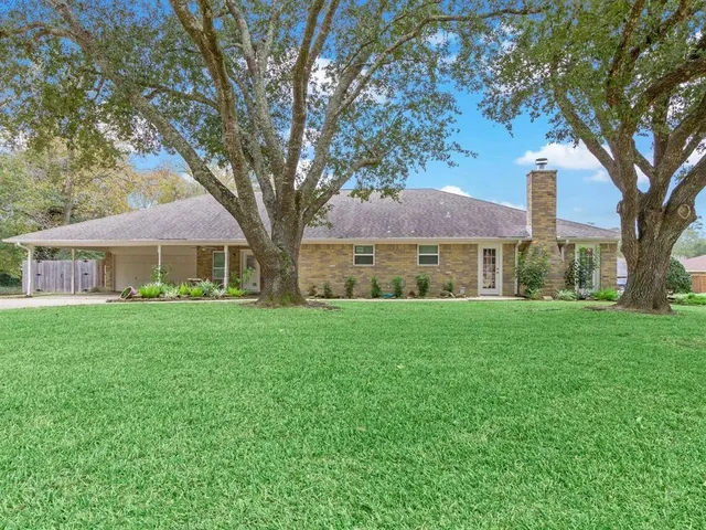a kitchen with a sink a stove and chairs