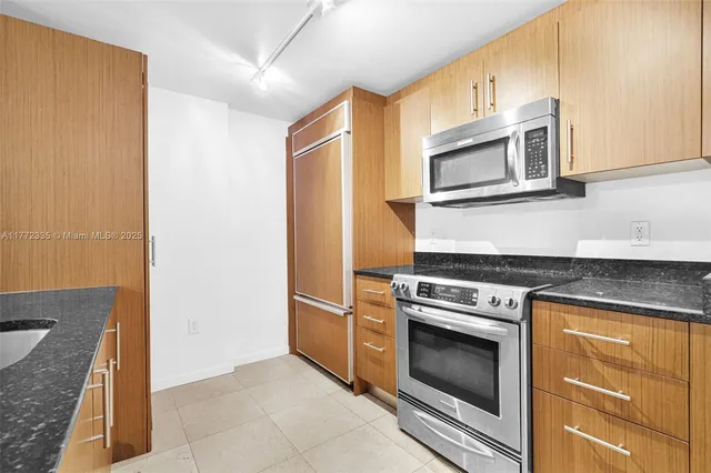 a view of a livingroom with furniture and floor to ceiling window