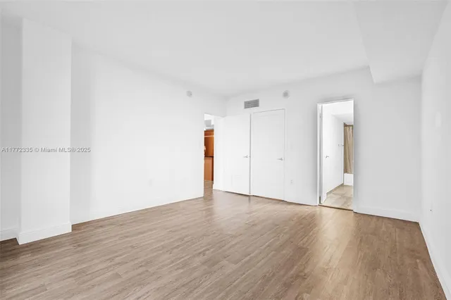 a kitchen with a sink a stove and cabinets