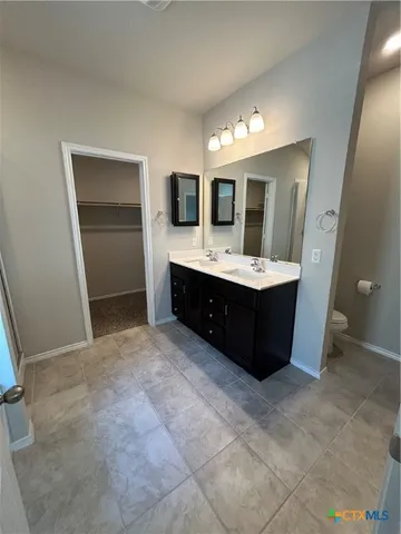 a spacious bathroom with a tub sink and mirror