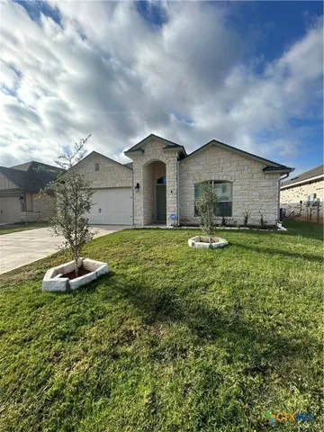 a front view of a house with a yard
