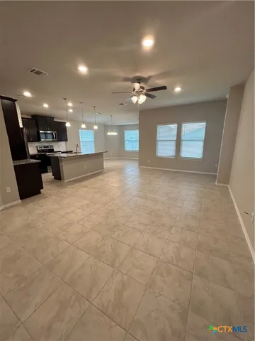 a view of a lobby with furniture and a ceiling fan