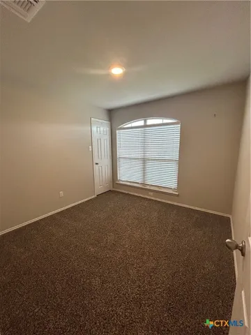 an empty room with a empty space and windows