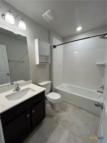 a bathroom with a double vanity sink toilet and shower