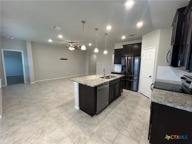 a kitchen with a sink and a refrigerator