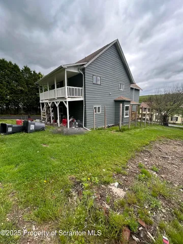 a view of a house with a yard and sitting area