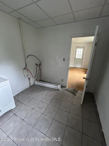 a view of empty room with wooden floor