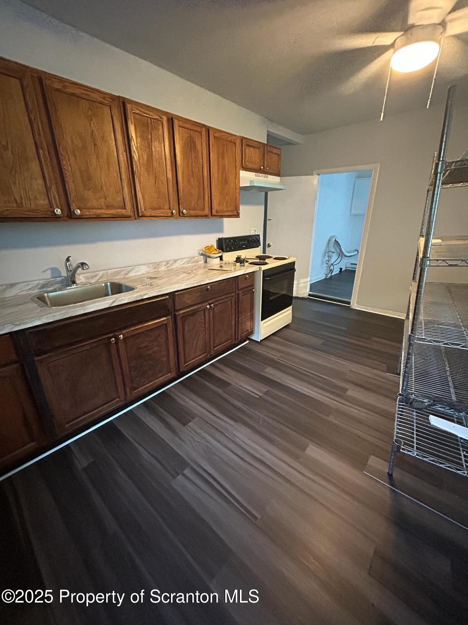 1177 North Main Street Forest City, PA 18421 - Photo 24 of 27 a kitchen with granite countertop wooden cabinets stainless steel appliances and a sink