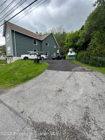 a front view of a house with a garden and patio