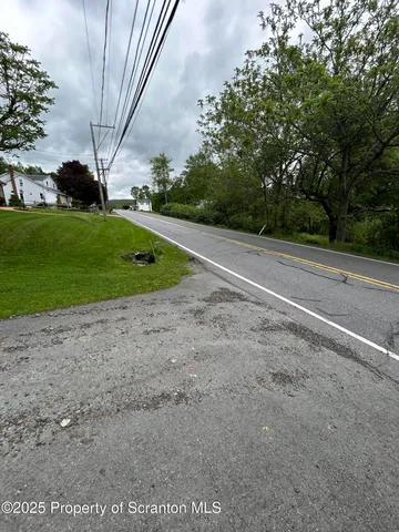 a view of a field with trees