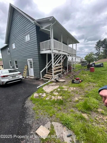 a view of a backyard with a table and chairs and potted plants