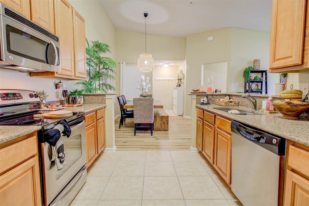 2344 Golden Lake Loop St. Augustine, FL 32084 - Photo 13 of 35 a kitchen with stainless steel appliances granite countertop a sink stove and cabinets