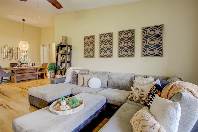 a living room with a couch and paintings on the wall