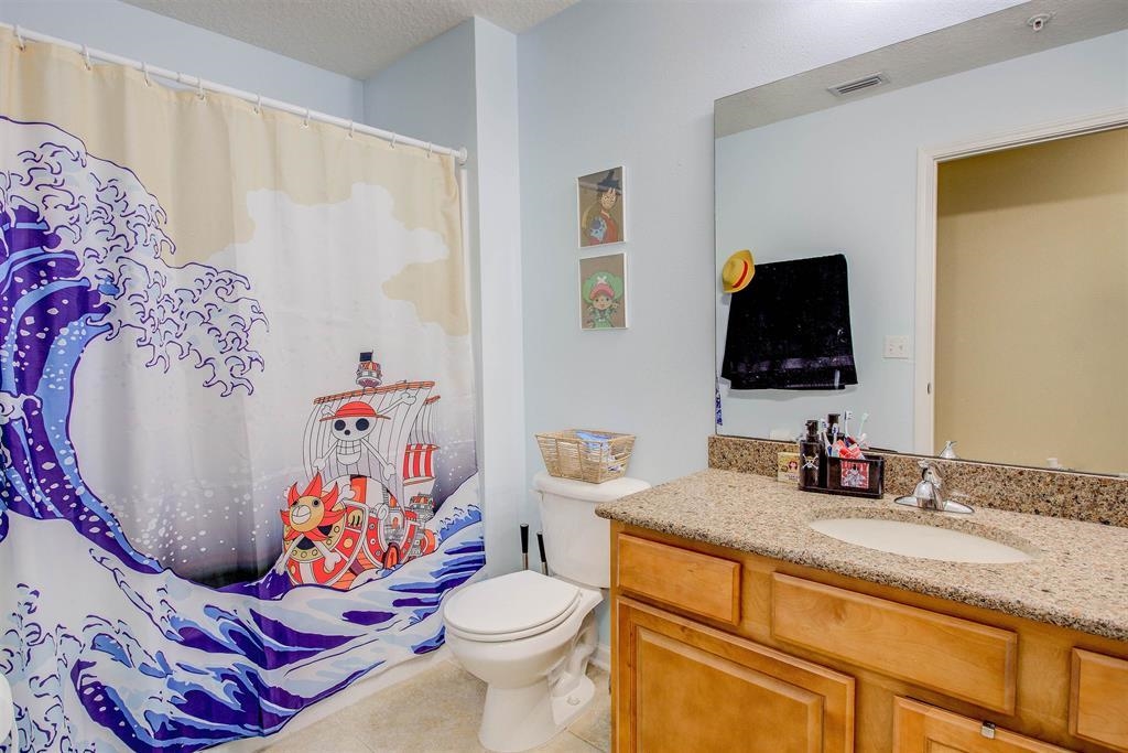 2344 Golden Lake Loop St. Augustine, FL 32084 - Photo 24 of 35 a bathroom with a sink toilet and mirror
