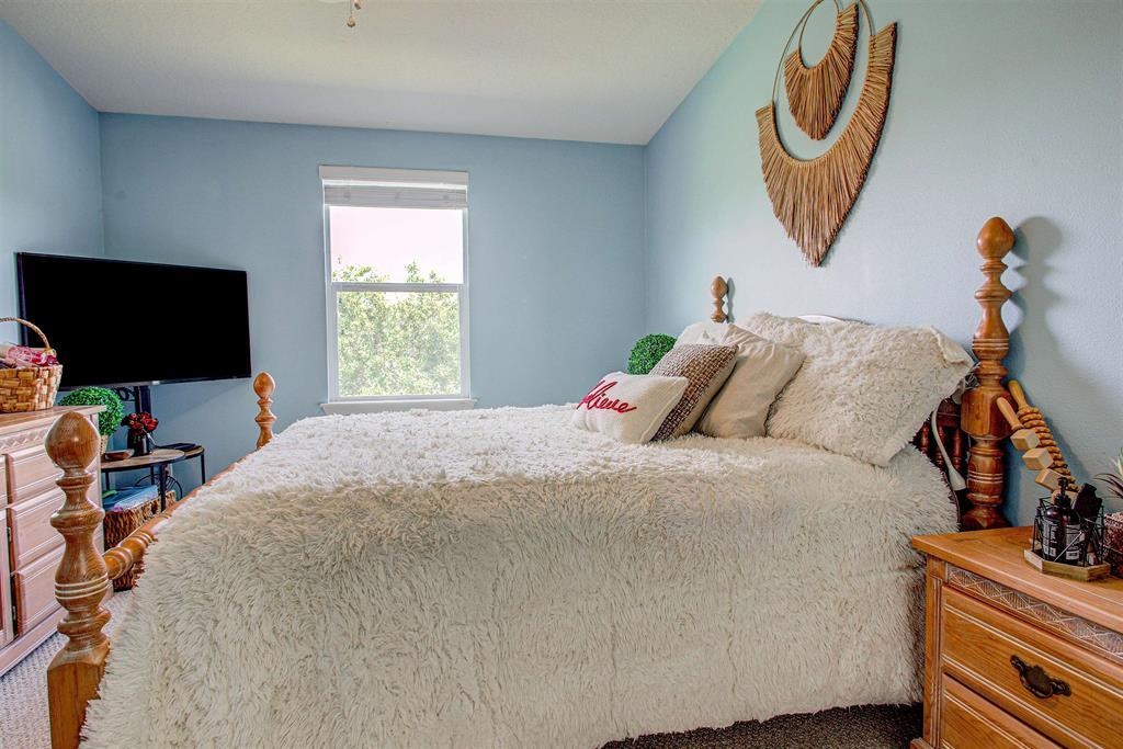 2344 Golden Lake Loop St. Augustine, FL 32084 - Photo 26 of 35 a bedroom with a bed and a flat screen tv