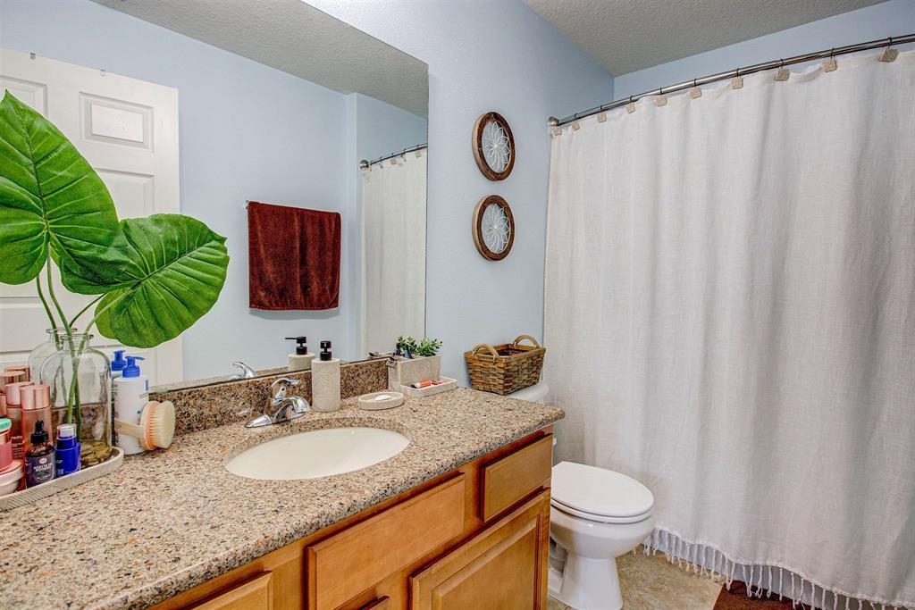2344 Golden Lake Loop St. Augustine, FL 32084 - Photo 29 of 35 a bathroom with a granite countertop sink and a mirror