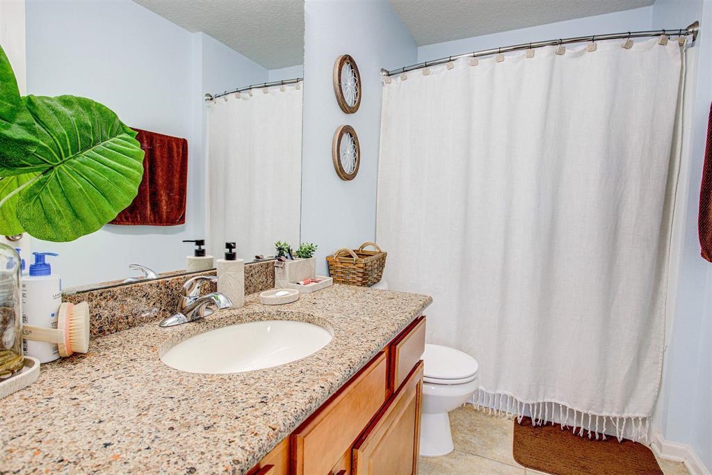 2344 Golden Lake Loop St. Augustine, FL 32084 - Photo 30 of 35 a bathroom with a granite countertop sink and a mirror