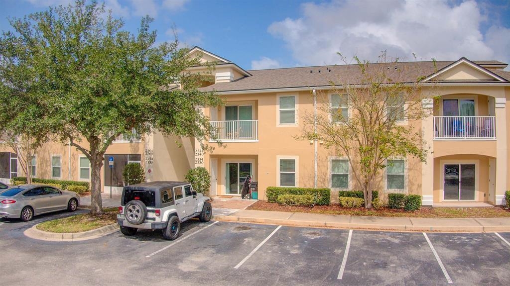 2344 Golden Lake Loop St. Augustine, FL 32084 - Photo 4 of 35 a front view of a house with a garden and parking