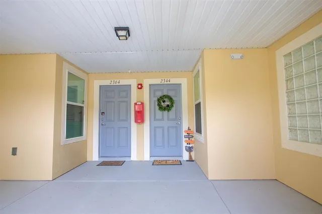 a view of an empty room with window and refrigerator