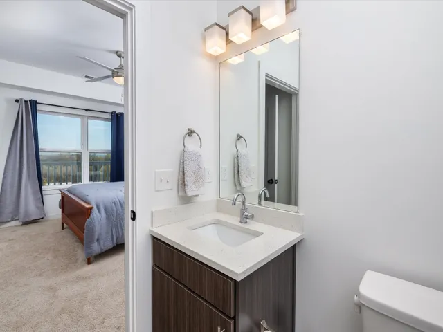 a bathroom with a sink a light fixture and a mirror