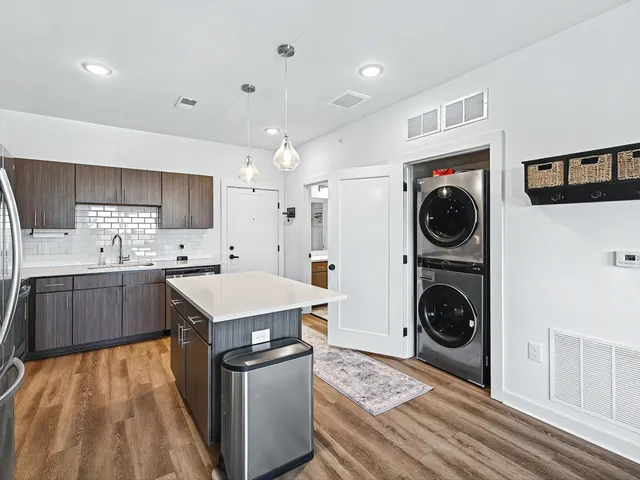 a kitchen with a stove sink and a refrigerator