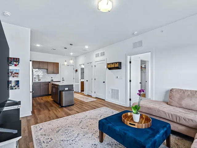 a living room with furniture kitchen view and a table