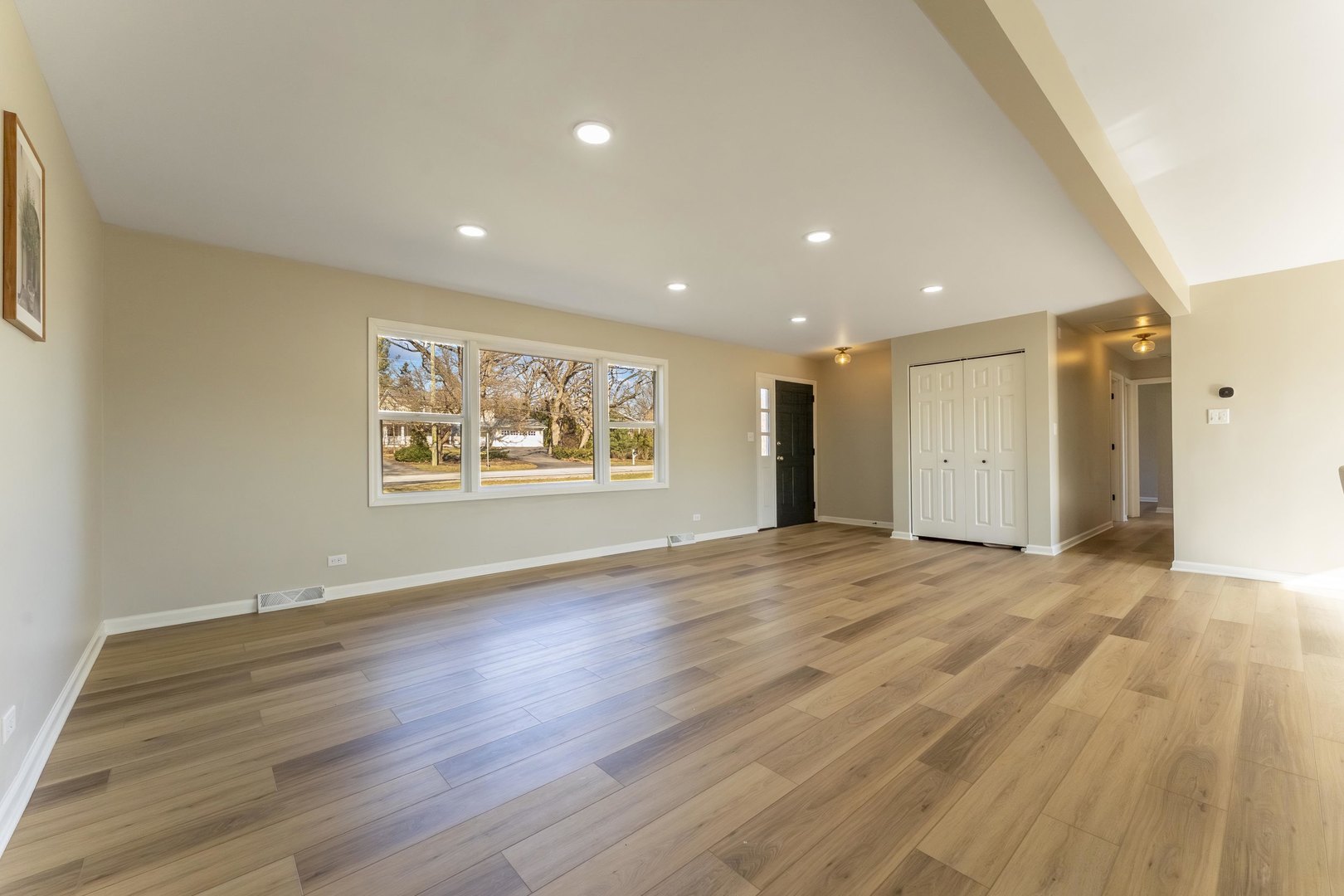 27-w073 Jewell Road Winfield, IL 60190 - Photo 9 of 34 a view of an empty room with wooden floor and a window