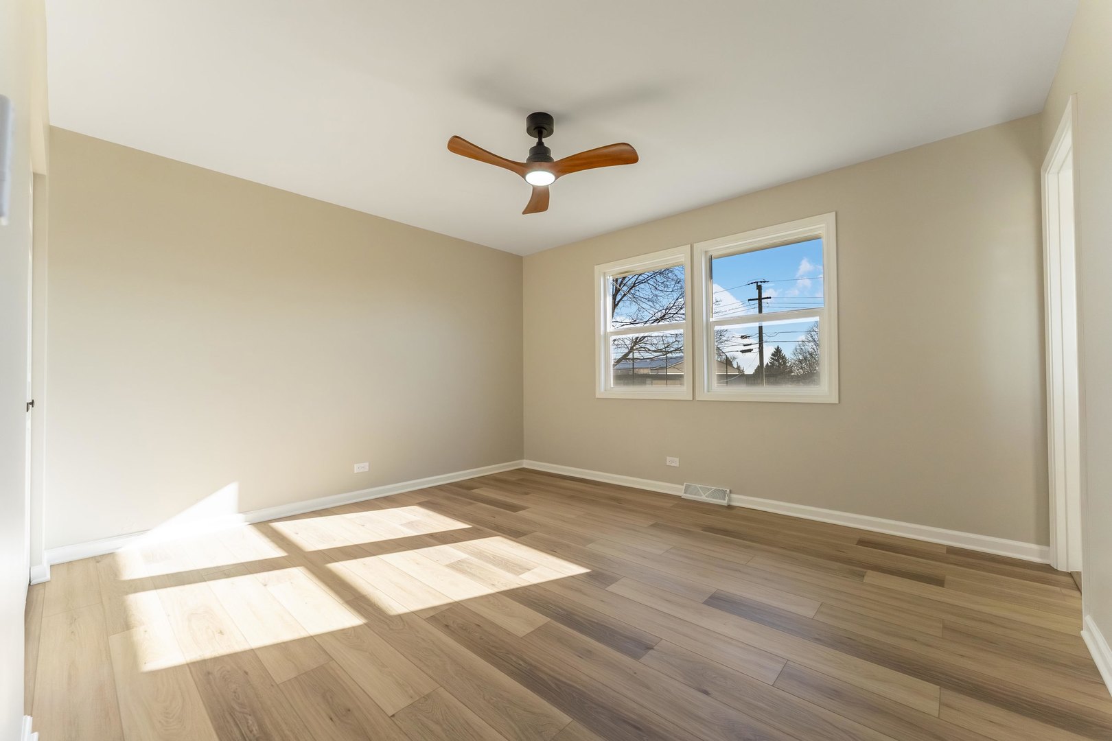 27-w073 Jewell Road Winfield, IL 60190 - Photo 10 of 34 a view of empty room with wooden floor and fan