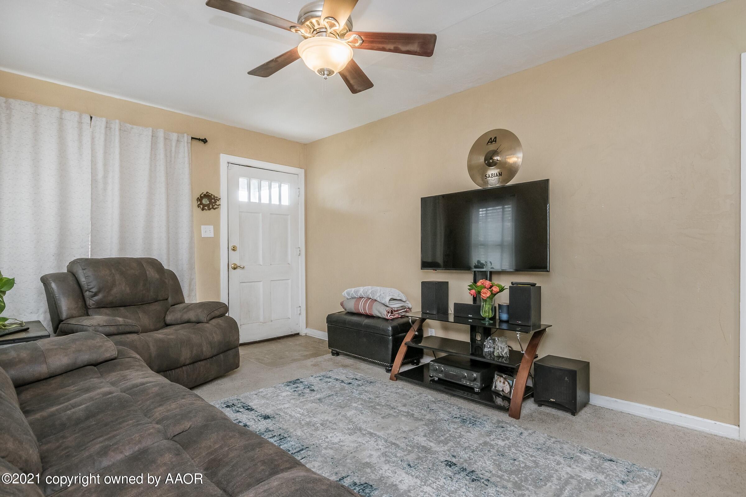 4100 South Ong Street Amarillo, TX 79110 - Photo 3 of 20 a living room with furniture and a flat screen tv