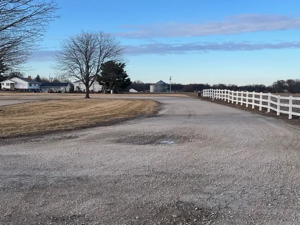 a view of dirt field with trees