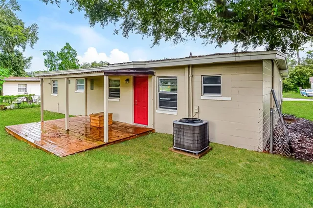 a front view of house with a garden and yard