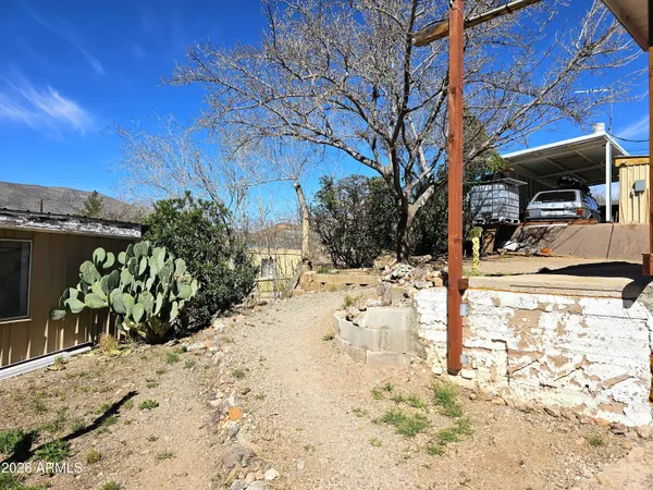 a view of a backyard with seating area