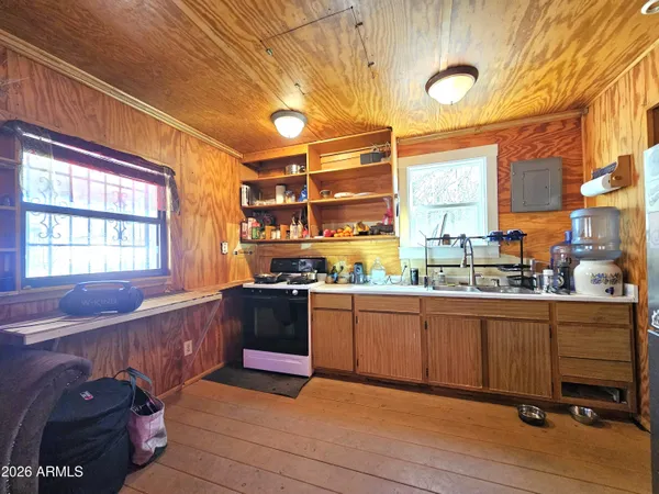a large kitchen with granite countertop a sink and cabinets