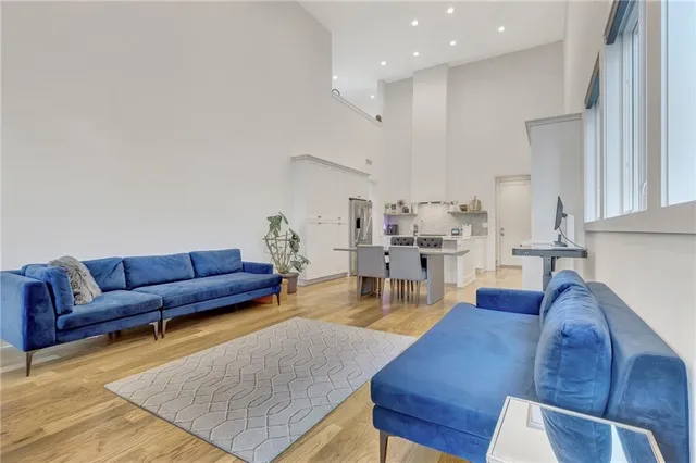 a living room with furniture wooden floor and a flat screen tv