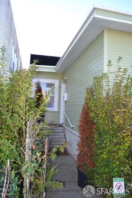 329 Faxon Avenue San Francisco, CA 94112 - Photo 3 of 6 a yellow house with flower garden