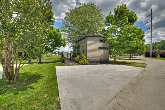 a view of a house with a yard and tree s