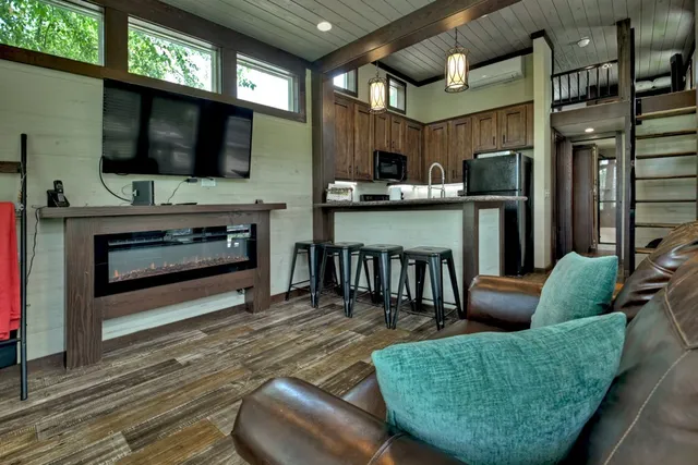 a living room with furniture a flat screen tv and a fireplace