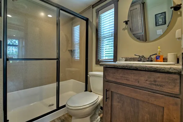 a bathroom with a sink toilet and shower