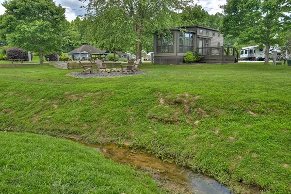 a view of a house with backyard and sitting area